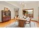 Dining room with hardwood floors, area rug, and modern lighting, ideal for Gathering meals and entertaining at 1555 Waterwitch Dr, Orlando, FL 32806