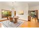 Bright dining room with modern lighting, area rug, hardwood floors, and a window with a backyard view at 1555 Waterwitch Dr, Orlando, FL 32806