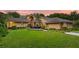 Charming home with manicured lawn, deck, and inviting entryway at sunset at 1555 Waterwitch Dr, Orlando, FL 32806