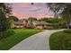 Charming home with manicured lawn, mature trees, and inviting entryway at 1555 Waterwitch Dr, Orlando, FL 32806