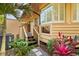 Charming home exterior featuring a wooden staircase, lush landscaping, and stylish architectural details at 1555 Waterwitch Dr, Orlando, FL 32806