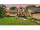 Inviting home with manicured lawn, deck, and welcoming entryway at sunset at 1555 Waterwitch Dr, Orlando, FL 32806