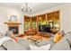 Cozy living room with fireplace, hardwood floors, and large windows at 1555 Waterwitch Dr, Orlando, FL 32806