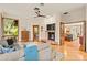 Open-concept living room featuring a fireplace, hardwood floors, and seamless flow to other living spaces at 1555 Waterwitch Dr, Orlando, FL 32806
