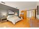 Main bedroom with hardwood floors, a decorative accent wall and a sliding door to an attached room at 1555 Waterwitch Dr, Orlando, FL 32806