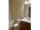 Cozy bathroom with single sink vanity, mirror, and shower-tub combo at 1711 Penrith Loop, Orlando, FL 32824