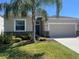 Charming single-Gathering home featuring a well-manicured lawn and a two-car garage at 1711 Penrith Loop, Orlando, FL 32824
