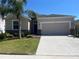 Charming single-Gathering home featuring a well-manicured lawn and a two-car garage at 1711 Penrith Loop, Orlando, FL 32824