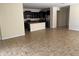 Bright living room with tile floors adjacent to a modern open-concept kitchen at 1711 Penrith Loop, Orlando, FL 32824