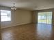 Bright living room featuring tile floors, large window, and sliding door to the backyard at 1711 Penrith Loop, Orlando, FL 32824