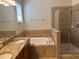Main bathroom featuring double sinks, granite countertops, and a separate shower and tub at 1711 Penrith Loop, Orlando, FL 32824