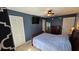 Cozy bedroom with a navy blue accent wall and carpet flooring, offering a relaxing retreat at 1720 Hope Dr, Ormond Beach, FL 32174