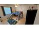 Bright bedroom featuring a loft bed with a slide, playful decor, and tiled flooring at 1720 Hope Dr, Ormond Beach, FL 32174