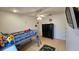 Well-lit bedroom featuring a playful car rug, tiled floors, and a traditional black dresser at 1720 Hope Dr, Ormond Beach, FL 32174
