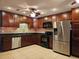 Well-equipped kitchen with stainless steel appliances, dark wood cabinetry, and elegant countertops at 1720 Hope Dr, Ormond Beach, FL 32174