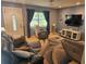 Comfortable living room with tile floors, contemporary furnishings, and a large window offering natural light at 1720 Hope Dr, Ormond Beach, FL 32174