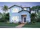 Charming two-story home with blue siding, stone accents, and a welcoming front porch at 17347 Beachgrass Aly, Winter Garden, FL 34787