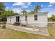 Spacious backyard with patio, swing and lush green grass, perfect for outdoor relaxation and entertainment at 18600 Old Cheney Hwy, Orlando, FL 32820