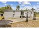 Spacious backyard with patio, swing and lush green grass, perfect for outdoor relaxation and entertainment at 18600 Old Cheney Hwy, Orlando, FL 32820
