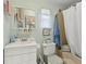 Cozy bathroom featuring a single sink vanity and a shower-tub combo with white shower curtain at 18600 Old Cheney Hwy, Orlando, FL 32820