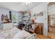 Bedroom with wood floors, white trundle bed, desk, shelves and window at 18600 Old Cheney Hwy, Orlando, FL 32820
