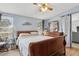 Bedroom features a ceiling fan, a wood bed frame and view to the living room at 18600 Old Cheney Hwy, Orlando, FL 32820