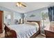 Bedroom featuring a ceiling fan, wood-look floors, and natural light at 18600 Old Cheney Hwy, Orlando, FL 32820