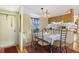 Bright dining area with a table set for six, adjacent to the kitchen at 18600 Old Cheney Hwy, Orlando, FL 32820