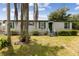 A cozy single-story home showcasing a well-maintained lawn and simple landscaping at 18600 Old Cheney Hwy, Orlando, FL 32820