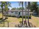 Exterior of the house with beautiful landscaping and mature palm trees at 18600 Old Cheney Hwy, Orlando, FL 32820