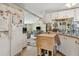 Open kitchen with white appliances and view of adjacent living area at 18600 Old Cheney Hwy, Orlando, FL 32820