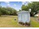 Exterior view of an outbuilding in backyard near chain link fence at 18600 Old Cheney Hwy, Orlando, FL 32820