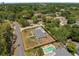 Aerial view of a property with a spacious lot, fenced yard, a private pool, surrounded by lush greenery at 197 Flame Ave, Maitland, FL 32751