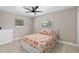 Bright bedroom features two windows, a ceiling fan, and a floral bedspread at 197 Flame Ave, Maitland, FL 32751