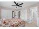 This bedroom features light wood floors, a floral bedspread, and ample closet space at 197 Flame Ave, Maitland, FL 32751