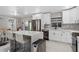 Bright kitchen featuring a large island with seating, stainless steel appliances, and modern white cabinets at 197 Flame Ave, Maitland, FL 32751