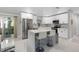 Modern kitchen with white cabinets, a center island with seating, and stainless steel appliances at 197 Flame Ave, Maitland, FL 32751