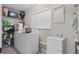 Well-lit laundry room features a washer, dryer, sink, and ample shelving at 197 Flame Ave, Maitland, FL 32751