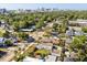 An aerial view of a charming neighborhood with mature trees and the city skyline in the background at 2107 Delaney Ave, Orlando, FL 32806