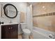 Tiled bathroom featuring a toilet and vanity with storage space at 2107 Delaney Ave, Orlando, FL 32806
