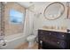 Modern bathroom featuring a shower/tub combo, single sink vanity, and tiled walls at 2107 Delaney Ave, Orlando, FL 32806