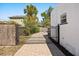 Paver driveway with a decorative metal gate, lush landscaping, and house view at 2107 Delaney Ave, Orlando, FL 32806