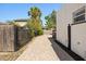 Paver driveway with a decorative metal gate, lush landscaping, and house view at 2107 Delaney Ave, Orlando, FL 32806