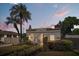 Charming bungalow featuring lush landscaping, arched entryway and a classic Mediterranean-style roof at 2107 Delaney Ave, Orlando, FL 32806