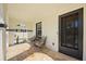 Cozy covered porch with tiled flooring and comfortable seating, perfect for enjoying the outdoors at 2107 Delaney Ave, Orlando, FL 32806