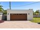 Detached garage with decorative carriage lights and lovely brick driveway at 2107 Delaney Ave, Orlando, FL 32806