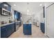 Spacious kitchen with blue cabinets, an island, and stainless steel appliances at 2107 Delaney Ave, Orlando, FL 32806