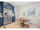 Cozy kitchen nook with stainless appliances, blue cabinets, and a round wooden table at 2107 Delaney Ave, Orlando, FL 32806
