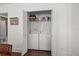 Laundry closet with shelving and a stacked washer and dryer at 2107 Delaney Ave, Orlando, FL 32806