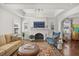 Elegant living room boasts a cozy fireplace, hardwood floors, and plenty of natural light at 2107 Delaney Ave, Orlando, FL 32806